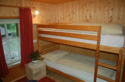 a bedroom with two bunk beds and a window at Agriturismo Feur Hof in San Martino in Badia