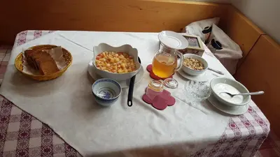 a table with food and drinks on a table at Agriturismo Feur Hof in San Martino in Badia
