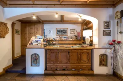 a large kitchen with an archway in a room at Hotel Canada in Predazzo