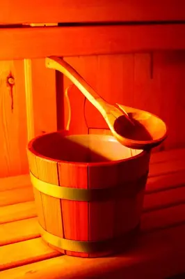 a wooden spoon sitting in a wooden bucket at Hotel Vajolet in Mazzin