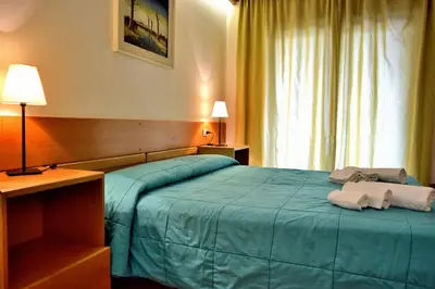 a hotel room with a bed with towels on it at Hotel Vajolet in Mazzin