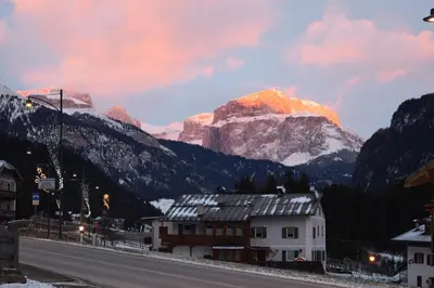 a mountain in the distance with a road in the foreground at Hotel Vajolet in Mazzin