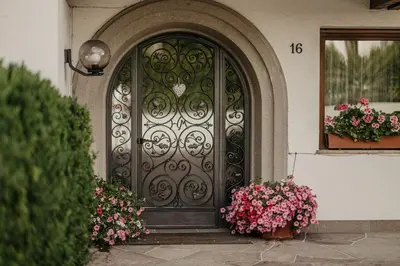 a door of a house with flowers in front of it at Apartments Thaler Irina in Ortisei
