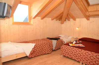 a hotel room with two beds and a tv at Hotel Corona in Carano