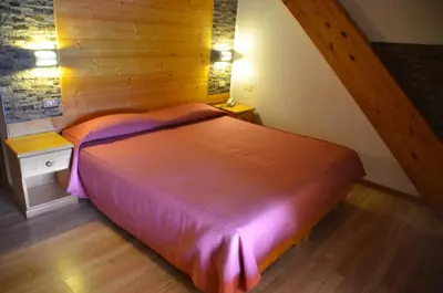 a bedroom with a large bed in a room at Hotel Corona in Carano