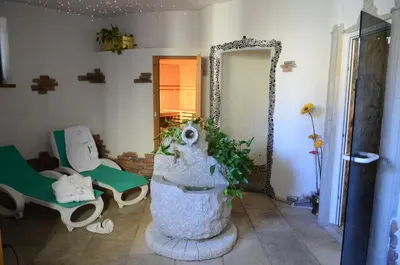 a room with a large statue in the middle of a room at Hotel Corona in Carano