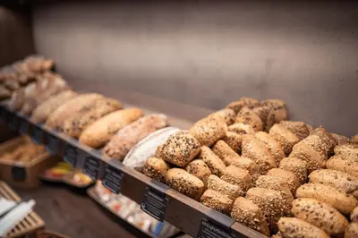 a display case filled with lots of different types of donuts at Quellenhof Luxury Resort Passeier in San Martino