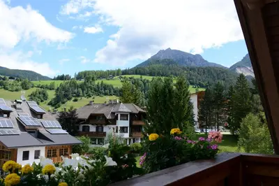 a view from a balcony of a village with flowers at Casa Teresa Martin in San Vigilio Di Marebbe