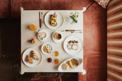a tray with plates of food on a table at Hotel Colbricon Beauty & Relax in San Martino di Castrozza