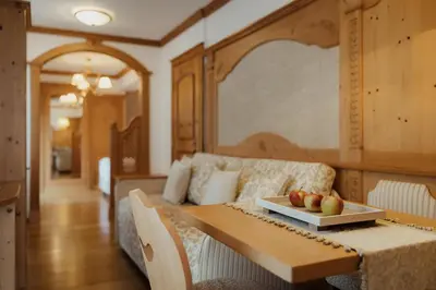 a bedroom with a bed and a table with apples on it at Hotel Colbricon Beauty & Relax in San Martino di Castrozza