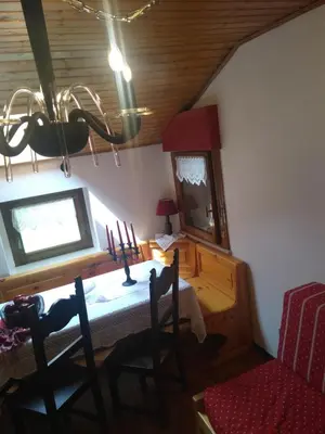 a dining room with a table and a mirror at Steila da Mont Campitello in Campitello di Fassa