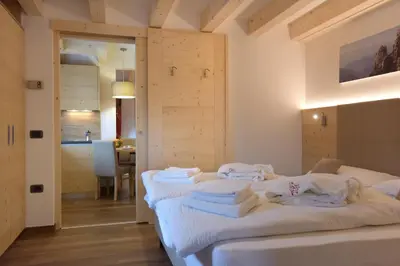 a room with a bed with towels on it at Agritur Darial in Tesero