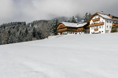 a house on top of a snow covered mountain at Niederhaeusererhof in Falzes