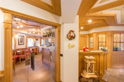 a kitchen with a glass door leading to a dining room at Garnì Prà Fiorì in Campitello di Fassa