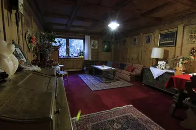 a living room with a couch and a table at Hotel Panorama in Cavalese