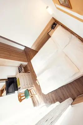 an overhead view of a bed in a tiny house at Hotel Panorama in Cavalese