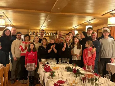 a group of people posing for a picture at a table at Hotel Panorama in Cavalese