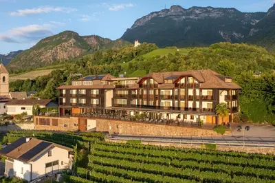 an exterior view of a building with purple lights at Hotel Christof in Appiano sulla Strada del Vino