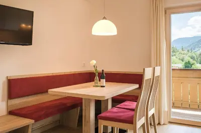 a dining room with a table and a window at Steinkellerhof in Vollan