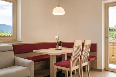 a dining room with a table and two chairs at Steinkellerhof in Vollan