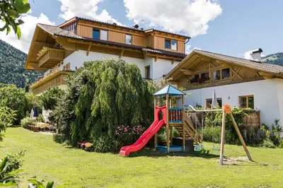 a playground in a yard in front of a house at Steinkellerhof in Vollan