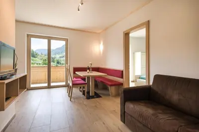 a living room with a couch and a table at Steinkellerhof in Vollan
