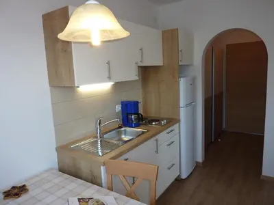 a small kitchen with a sink and a light at Appartement Windisch in Tirolo