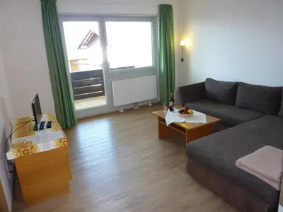 a living room with a couch and a table at Appartement Windisch in Tirolo