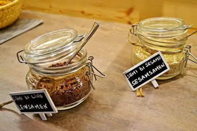two jars filled with spices sitting on top of a table at Agritur Scoiattolo in Coredo