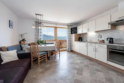 a kitchen and living room with a couch and a table at Apartments Schönblick in Mühlbach
