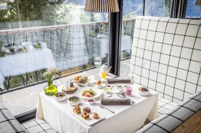a table with plates of food on a balcony at My Arbor - Dolomites in Bressanone