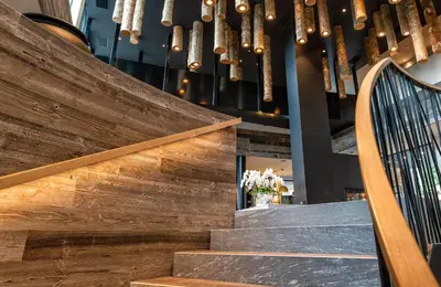 a group of chandeliers hanging above a staircase at My Arbor - Dolomites in Bressanone