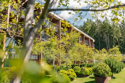 a building with trees and bushes in front of it at My Arbor - Dolomites in Bressanone