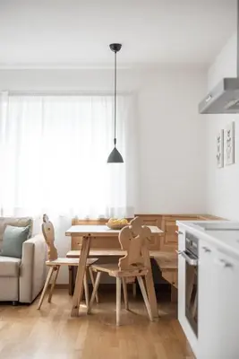 a kitchen and dining room with a table and chairs at Villa am Gries in Lana