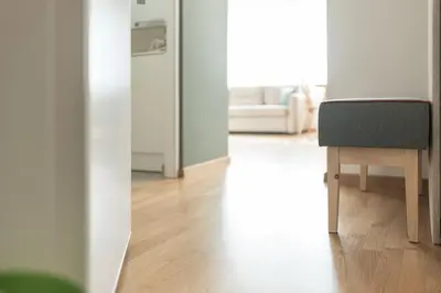 a living room with a chair and a refrigerator at Villa am Gries in Lana