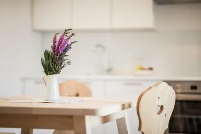 a vase of flowers sitting on a table in a kitchen at Villa am Gries in Lana
