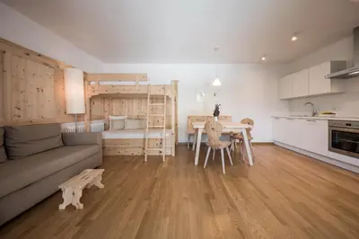 a kitchen and a living room with a couch and a table at Villa am Gries in Lana