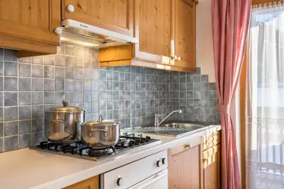 a kitchen with two pots on a stove at Apartments Primula in San Vigilio Di Marebbe