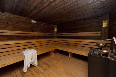 a large wooden sauna with a towel sitting in it at Hotel Waldhof in Perca