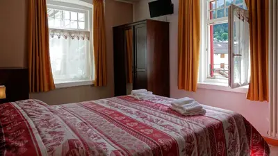 a bedroom with a bed with two towels on it at Soggiorno Dolomiti in Mazzin