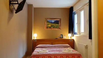 a bedroom with a bed with towels on it at Soggiorno Dolomiti in Mazzin