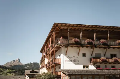 a building with balconies and flowers on it at Hotel Pider in La Valle