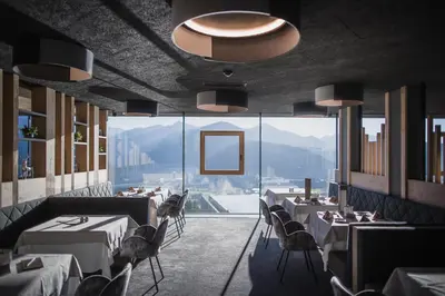 a building on the top of a mountain at Hotel Hubertus in Valdaora