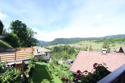 a view of a house with a garden at B.& B. Corradini in Castello di Fiemme
