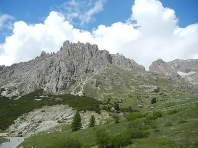 a mountain with a road in front of it at B.& B. Corradini in Castello di Fiemme