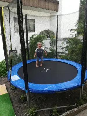 a little boy standing on a trampoline at App Brunner in Valdaora