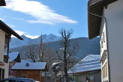 a city street with mountains in the background at App Brunner in Valdaora
