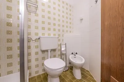 a bathroom with a toilet and a sink at App Brunner in Valdaora