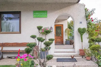 a building with potted plants in front of a door at App Brunner in Valdaora