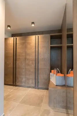 a walk in closet with wooden doors and bags at Moar am Ort in Schenna